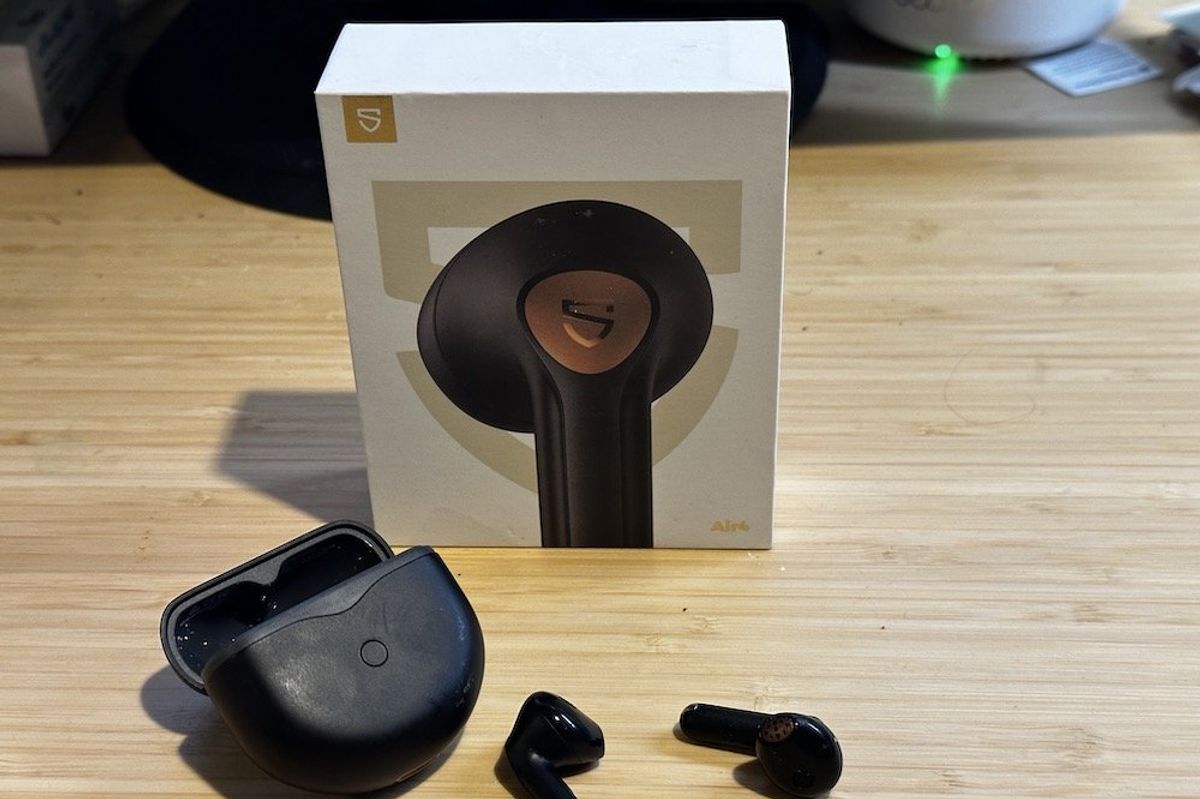 A photo of SoundPEATS Air4 Wireless Earbuds, case and box on a desk
