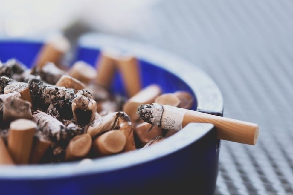 ash tray full of cigarette butts