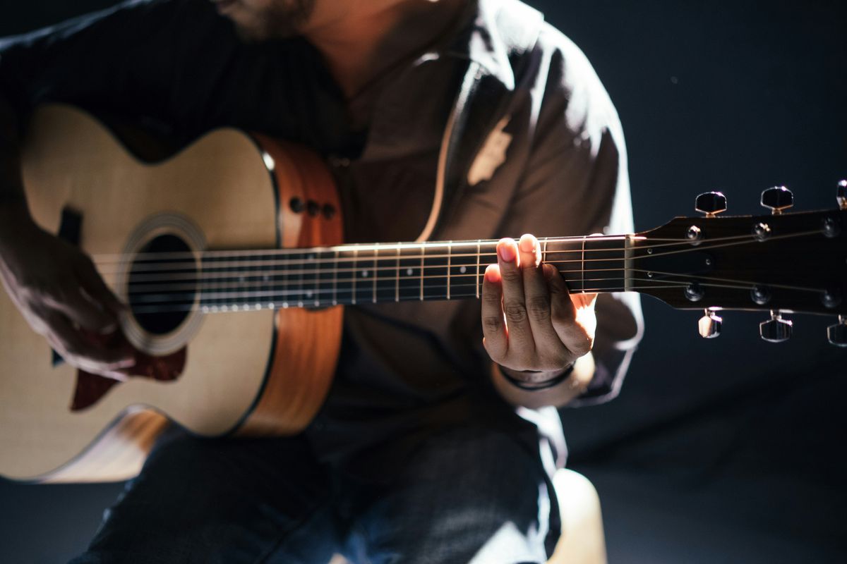 man playing acoustic guitar