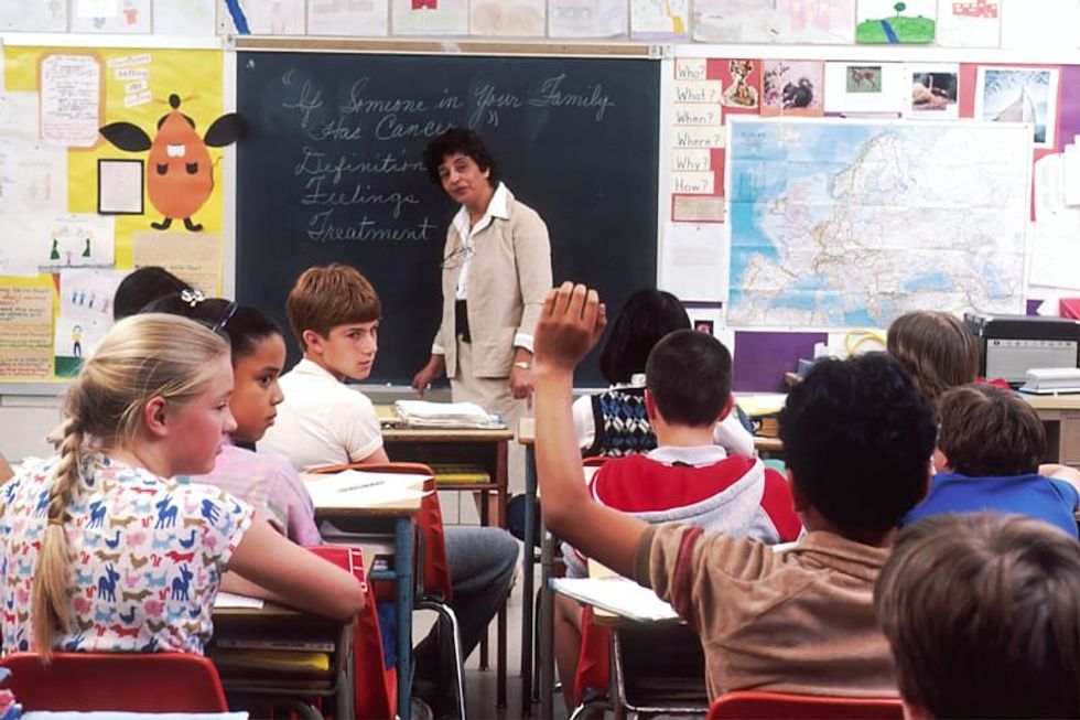 teacher standing in front of a class of students