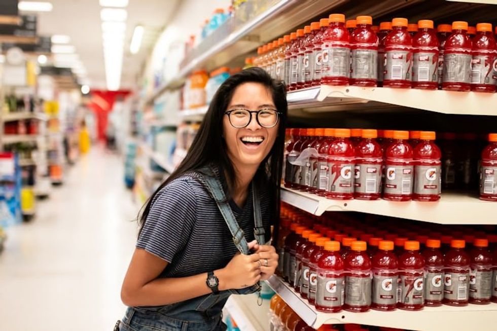 woman smiling in a grocery aisle