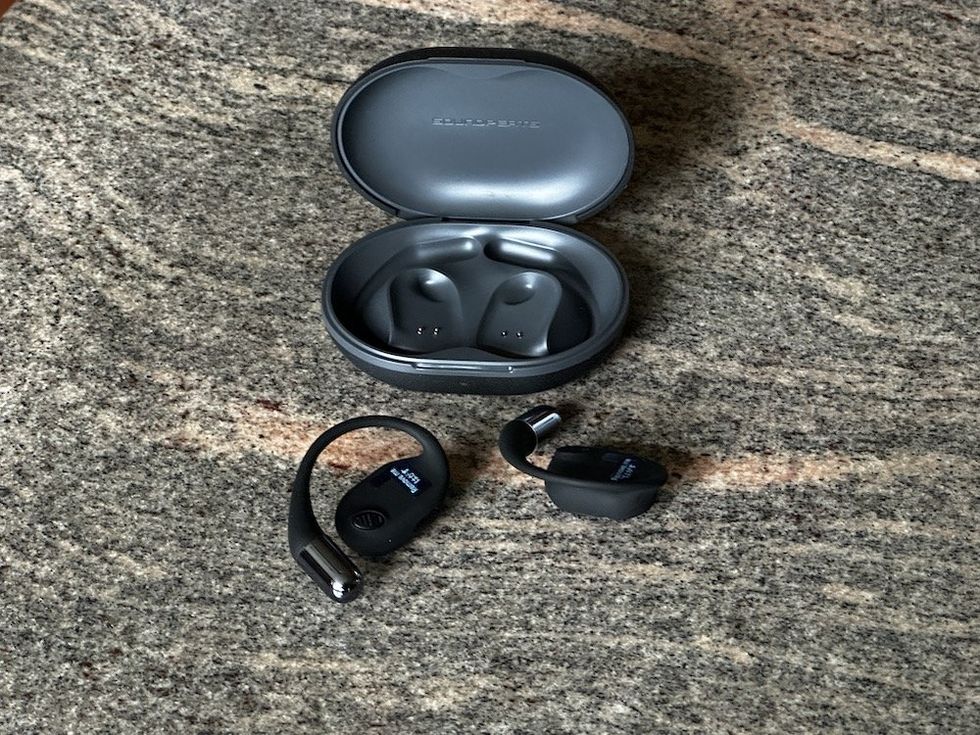 a photo of SoundPEATS GoFree2 Open Ear Headphones open charging case and earphones on a countertop