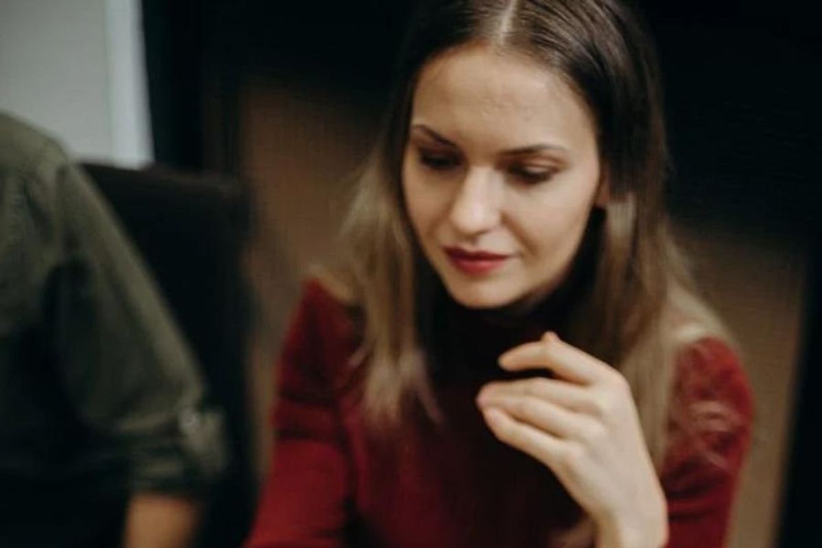 woman semi-smiling and looking down