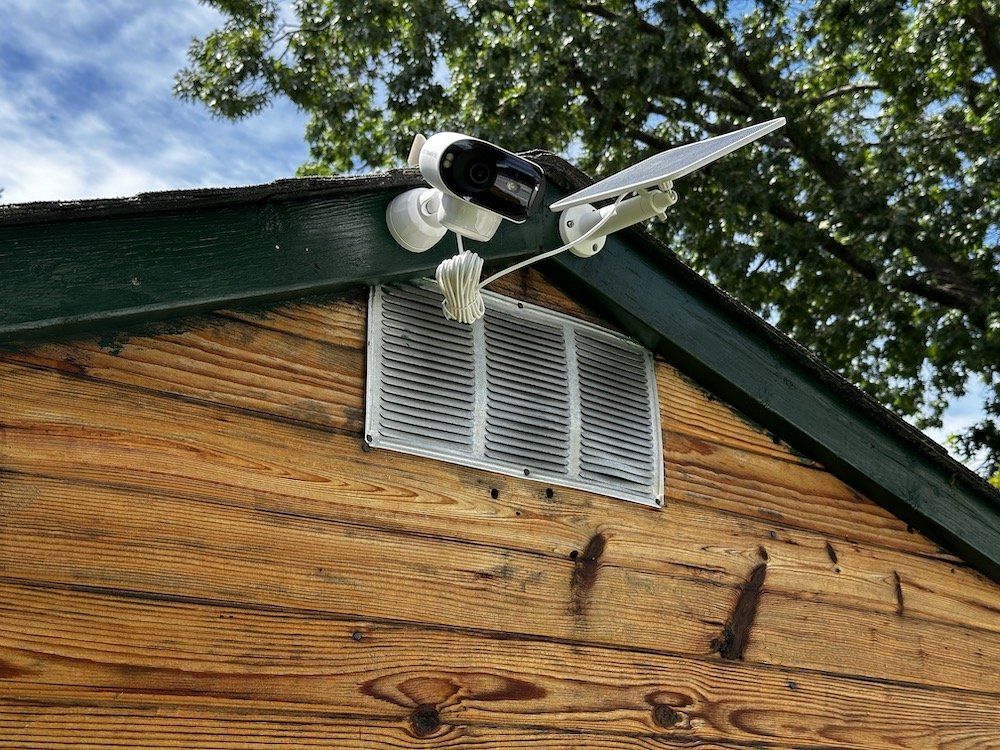 a photo of Reolink Argus 4 Pro and solar panel installed on a shed