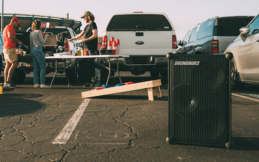a photo of a tailgate party with Soundboks speaker playing music