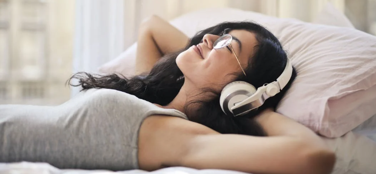 listening to music, learning a skill, woman in bed