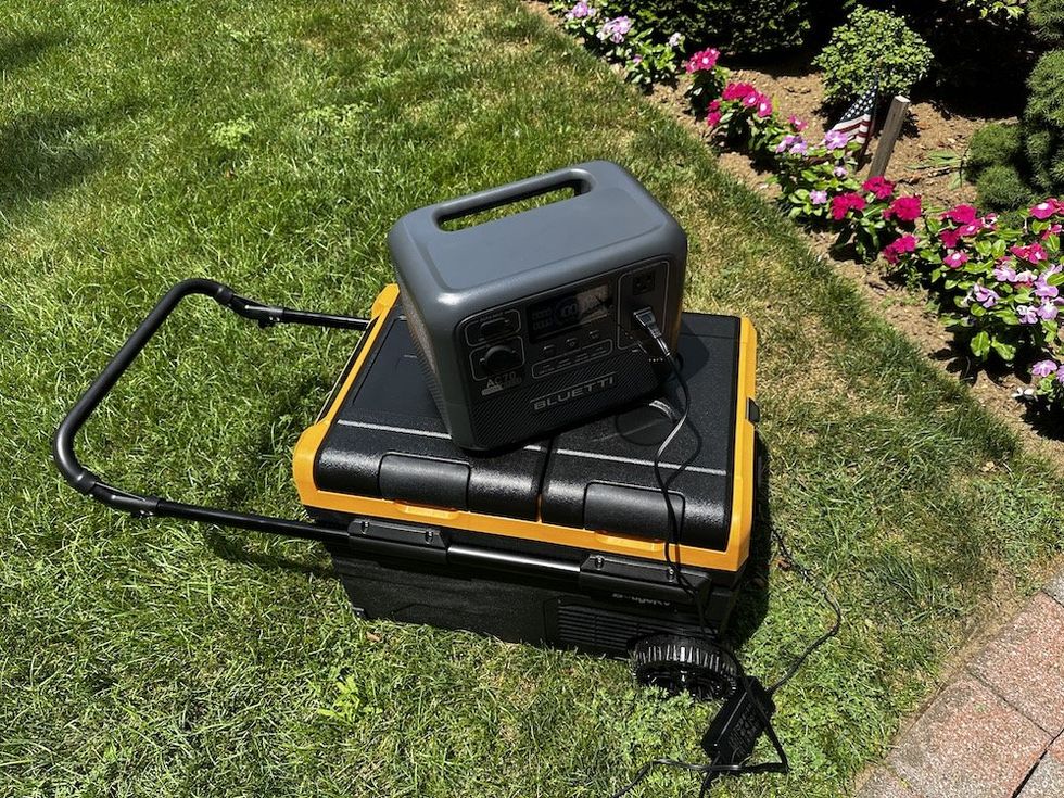 a photo of a portable power station powring BougeRV Dual Zone 12-Volt Car Refrigerator