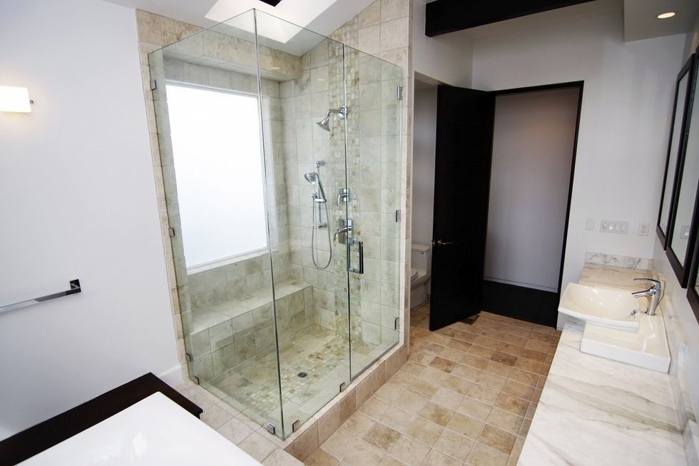 a photo of a clean shower with glass doors