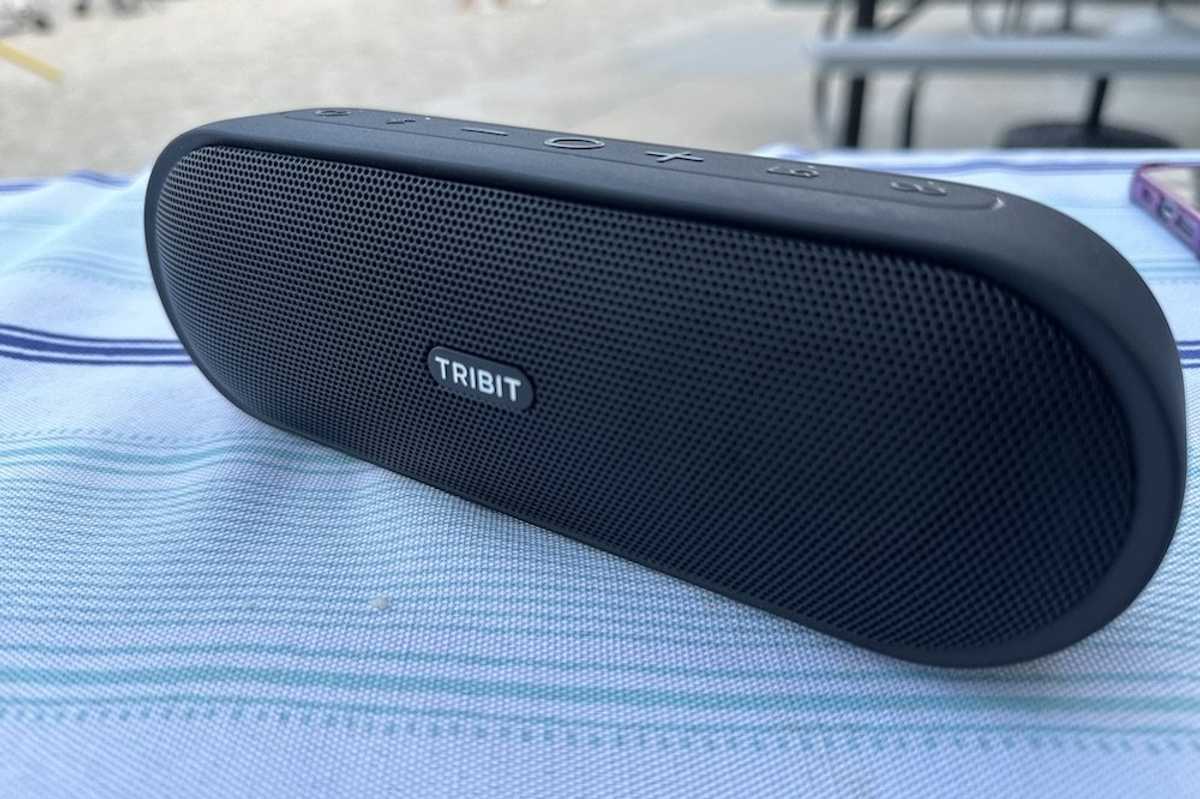 a photo of Tribit XSound Plus 2 Portable Wireless Speaker on a table at the beach
