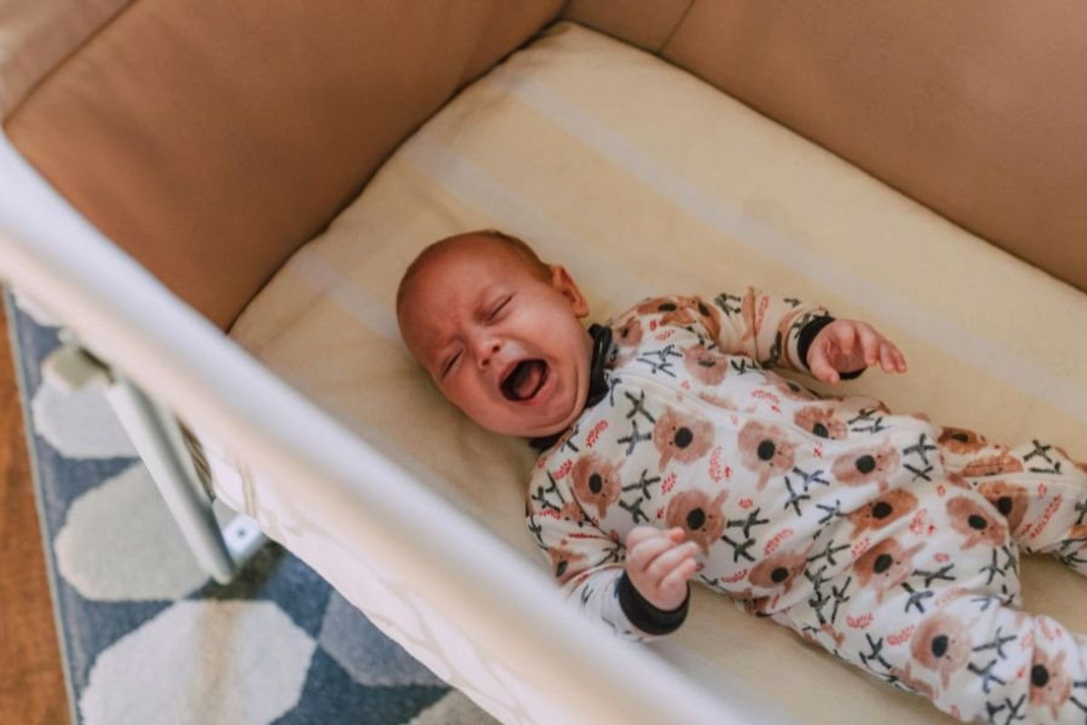 baby crying in a crib