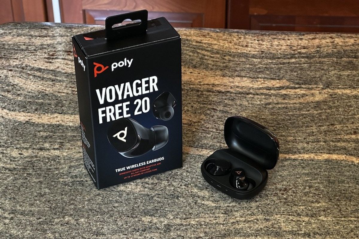 a photo ofo Poly Voyager Free 20 True Wireless Earbuds box and case opened on a counter