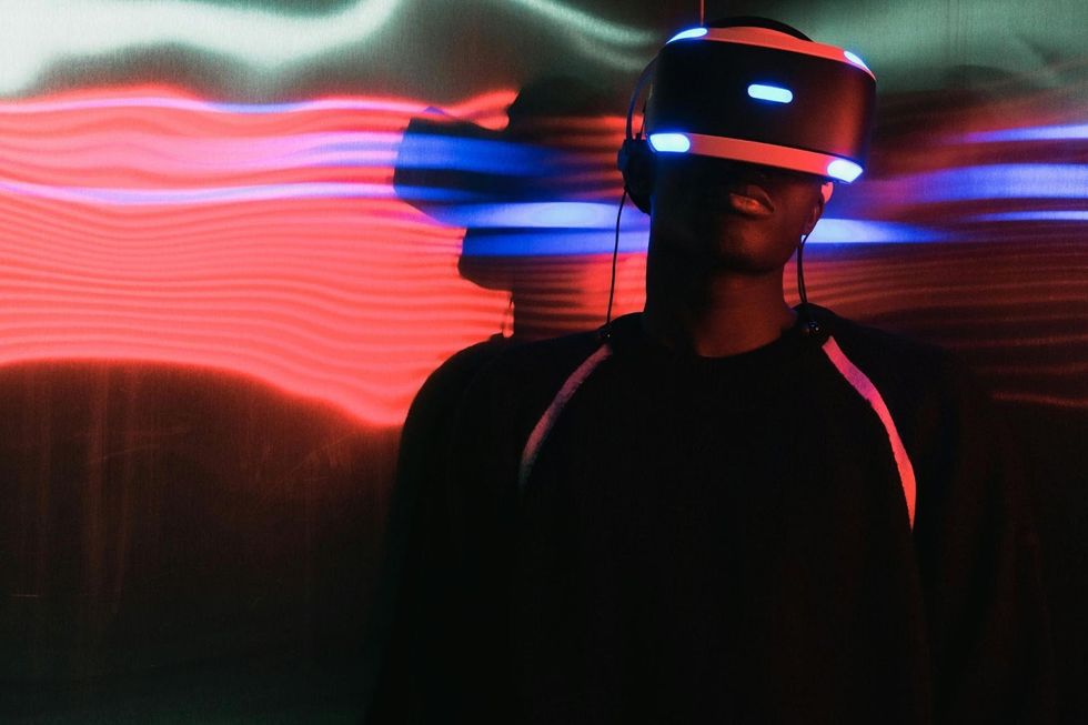 A photo of a male wearing tethered VR Headset