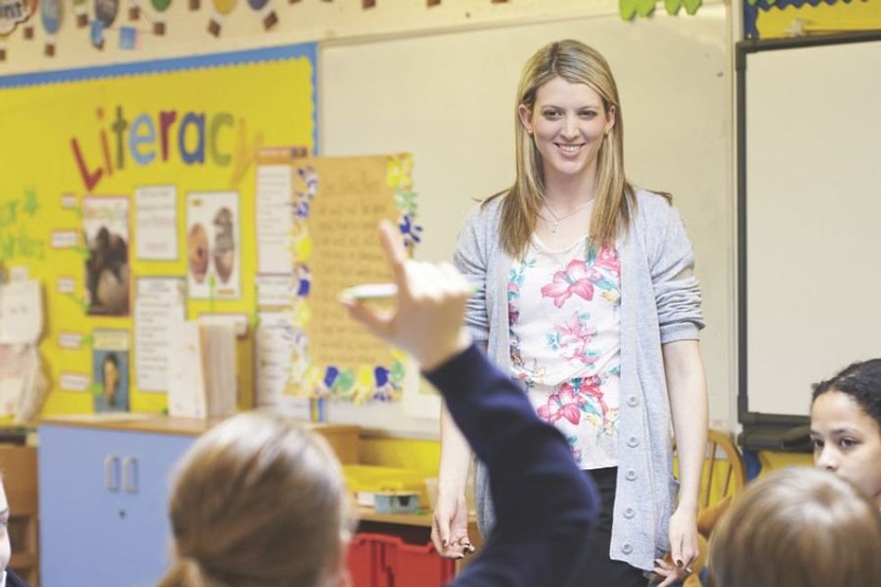 teacher standing in front of a classroom