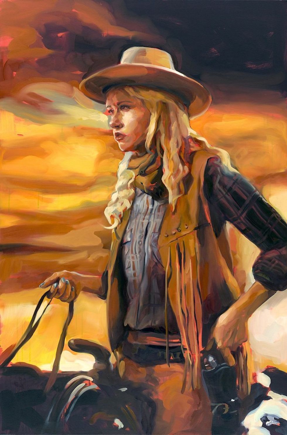 Woman in cowboy hat riding a horse and reaching for holster