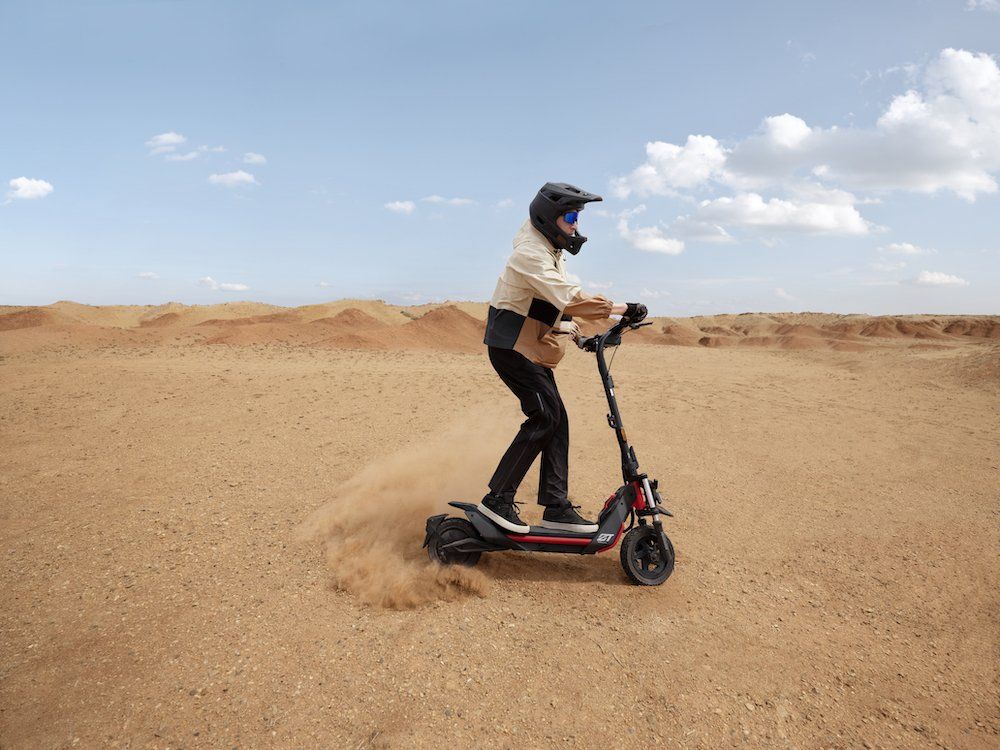 a man riding a Segway ZT3 Pro scooter in the desert