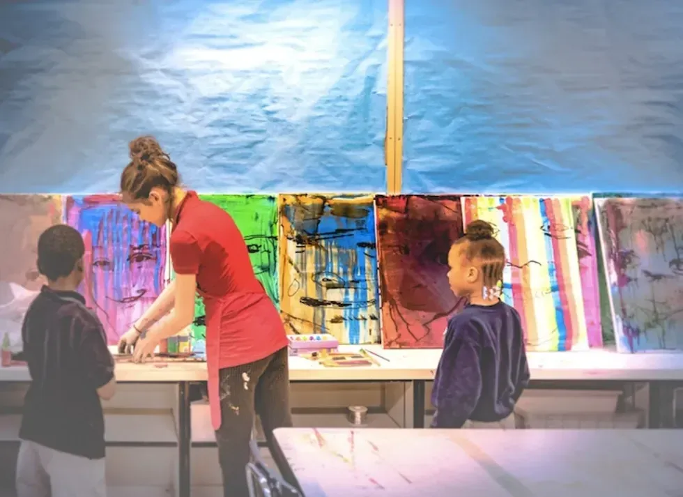 painting colorful abstract art on canvases.