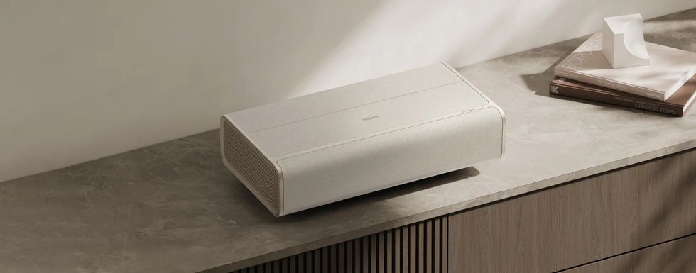 a photo of Xgimi Aura 2 Laser Projector on a crendenza.