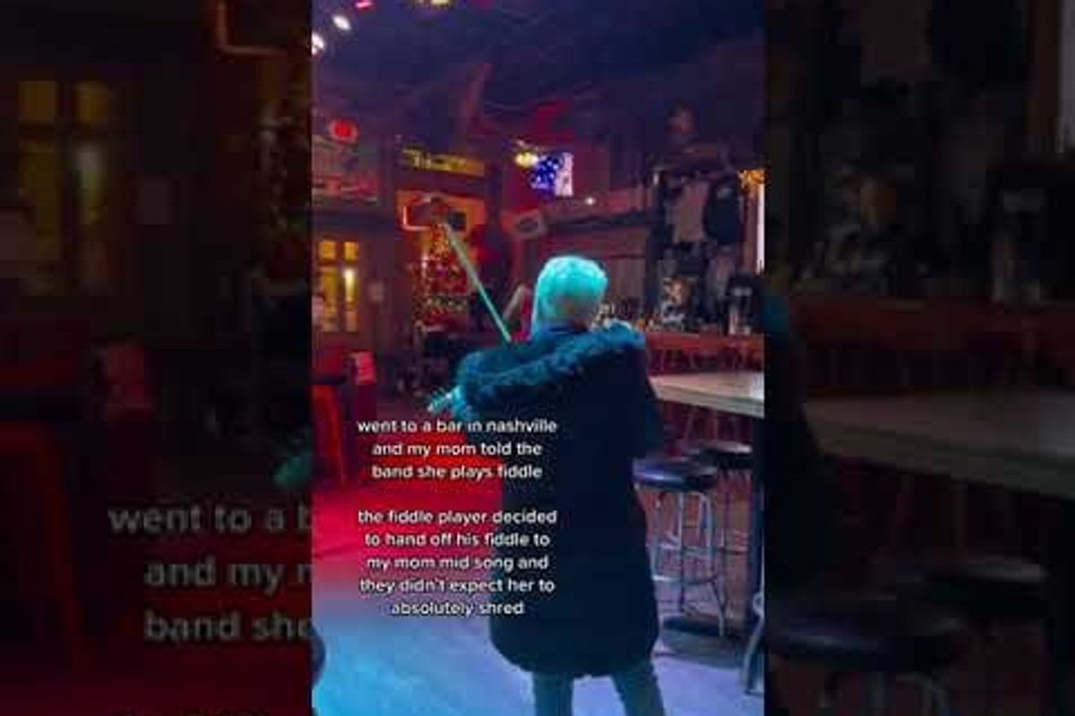 A mom mentioned she played the fiddle so the bar band handed her one. She totally shredded.