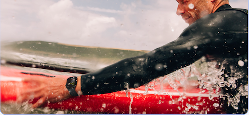 a photo of a male surfer wearing Apple Watch 10