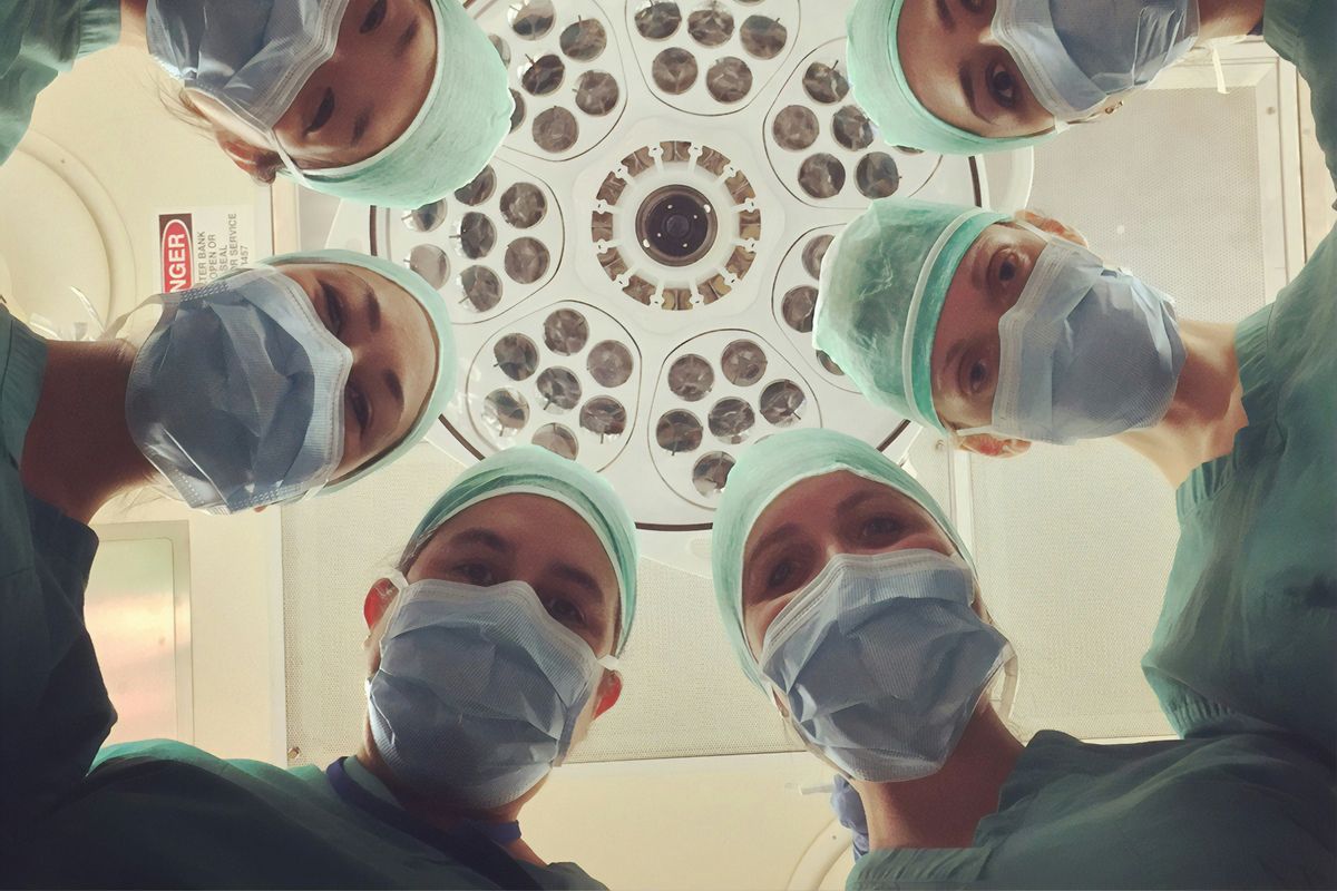 a team of doctors looking at the camera