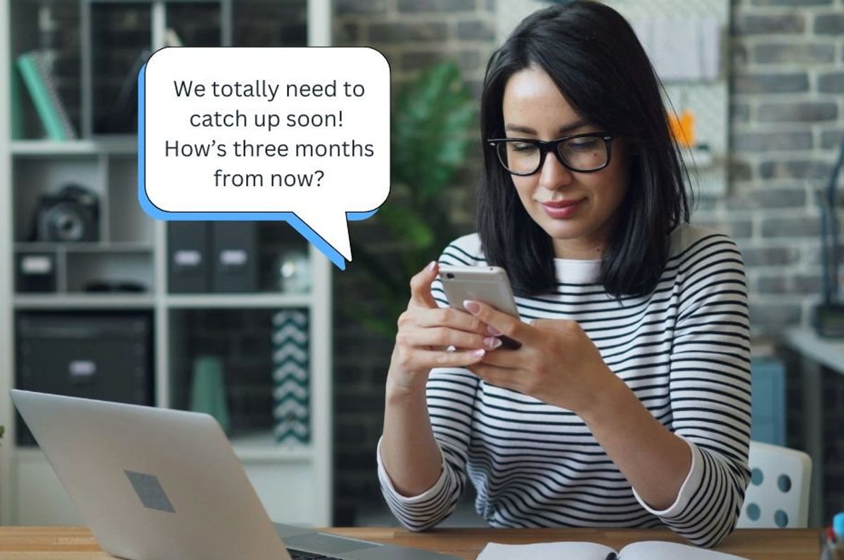 woman texting at a desk