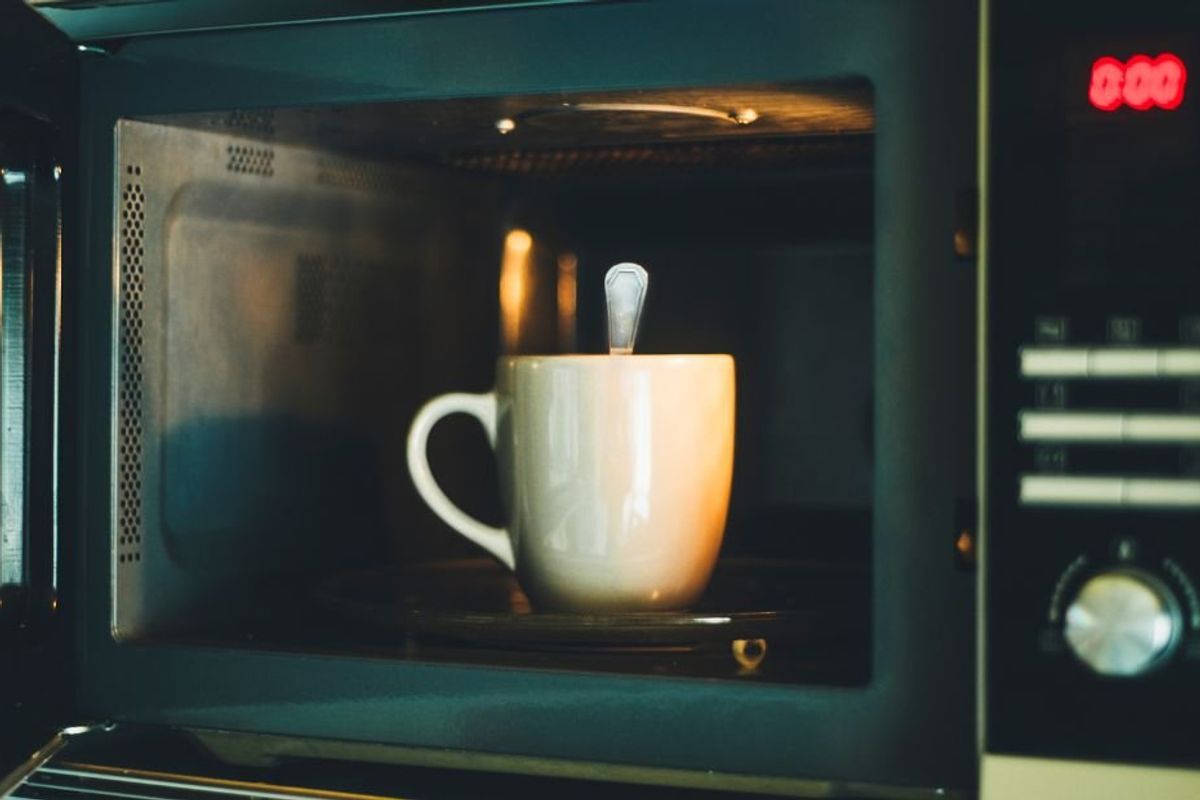 mug in microwave with a metal spoon in it
