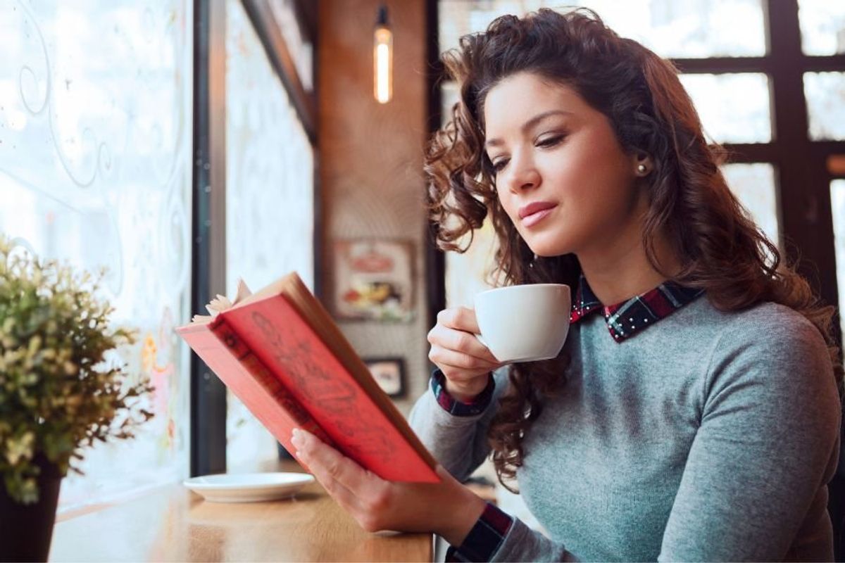 woman reading a book in a coffee shop