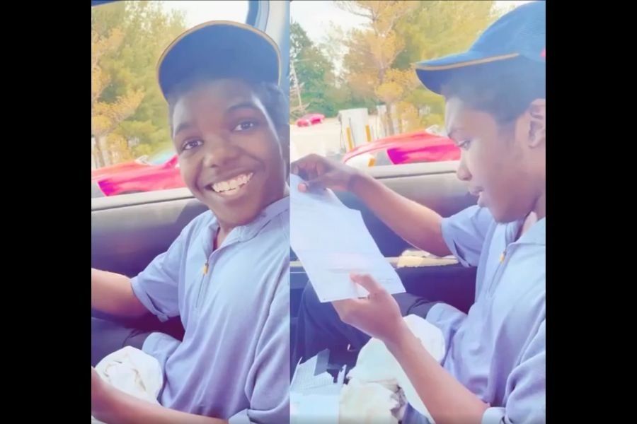 teen smiling and looking at paycheck