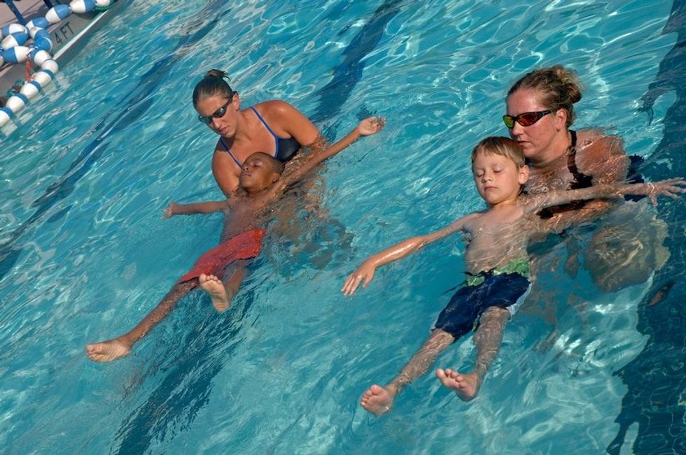 Swim instructor calms a teary toddler with his 'mermaid mantra' and now the adults are crying