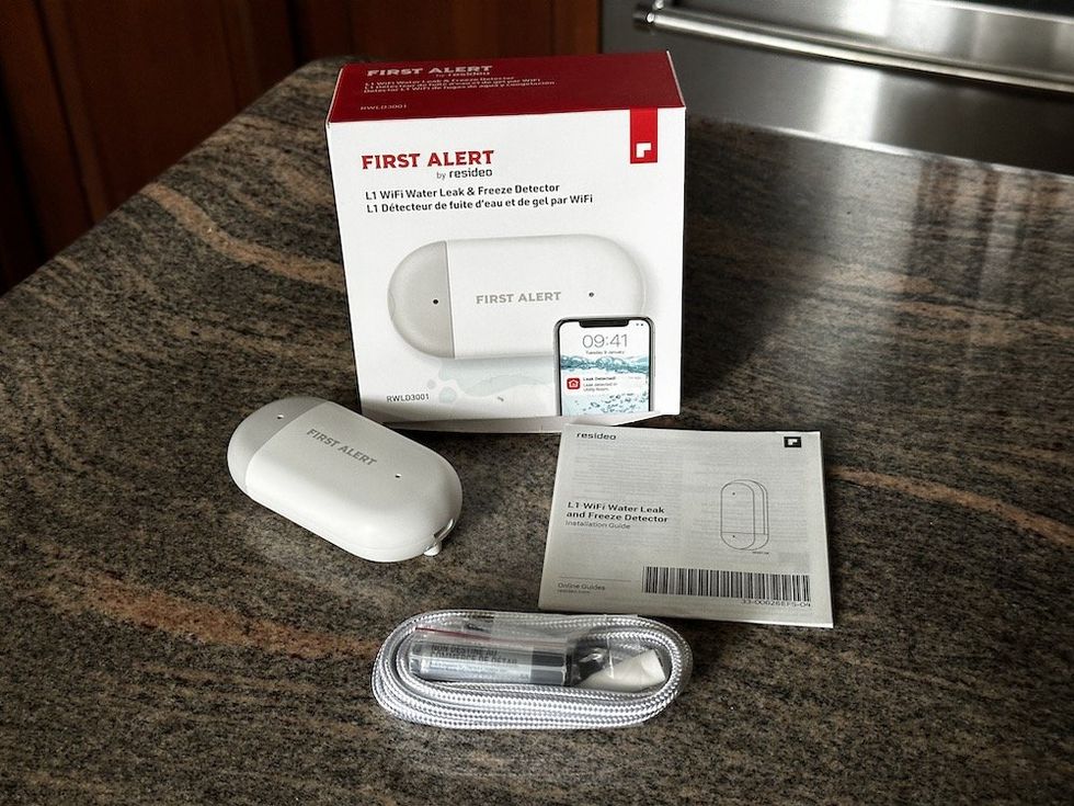 a photo of oFirst Alert by Resideo L1 WiFi Water Leak Detector and Freeze Detector unboxed