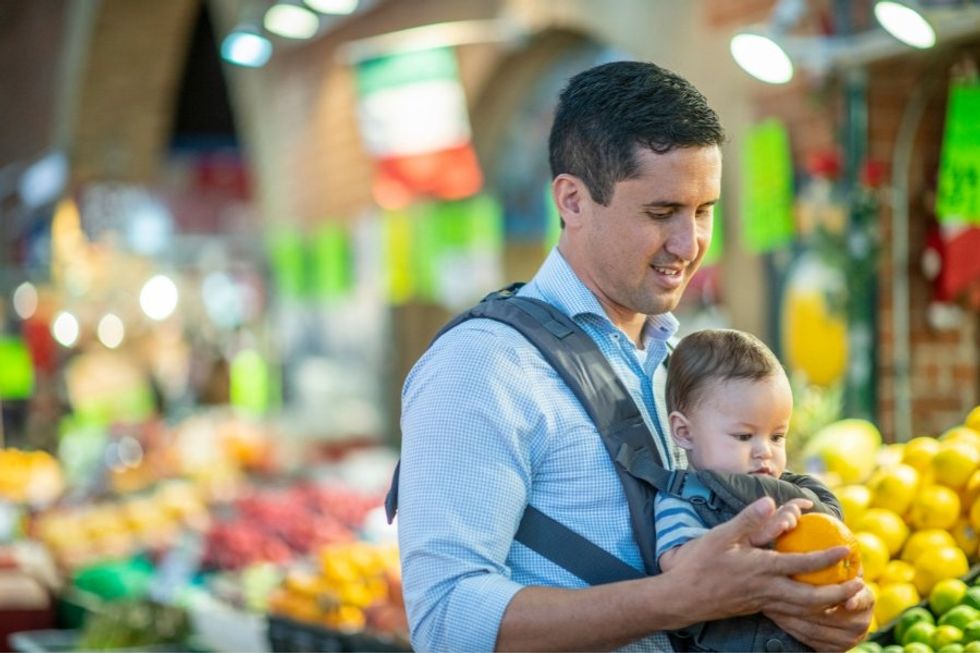 dad with baby in baby carrier at grocery store