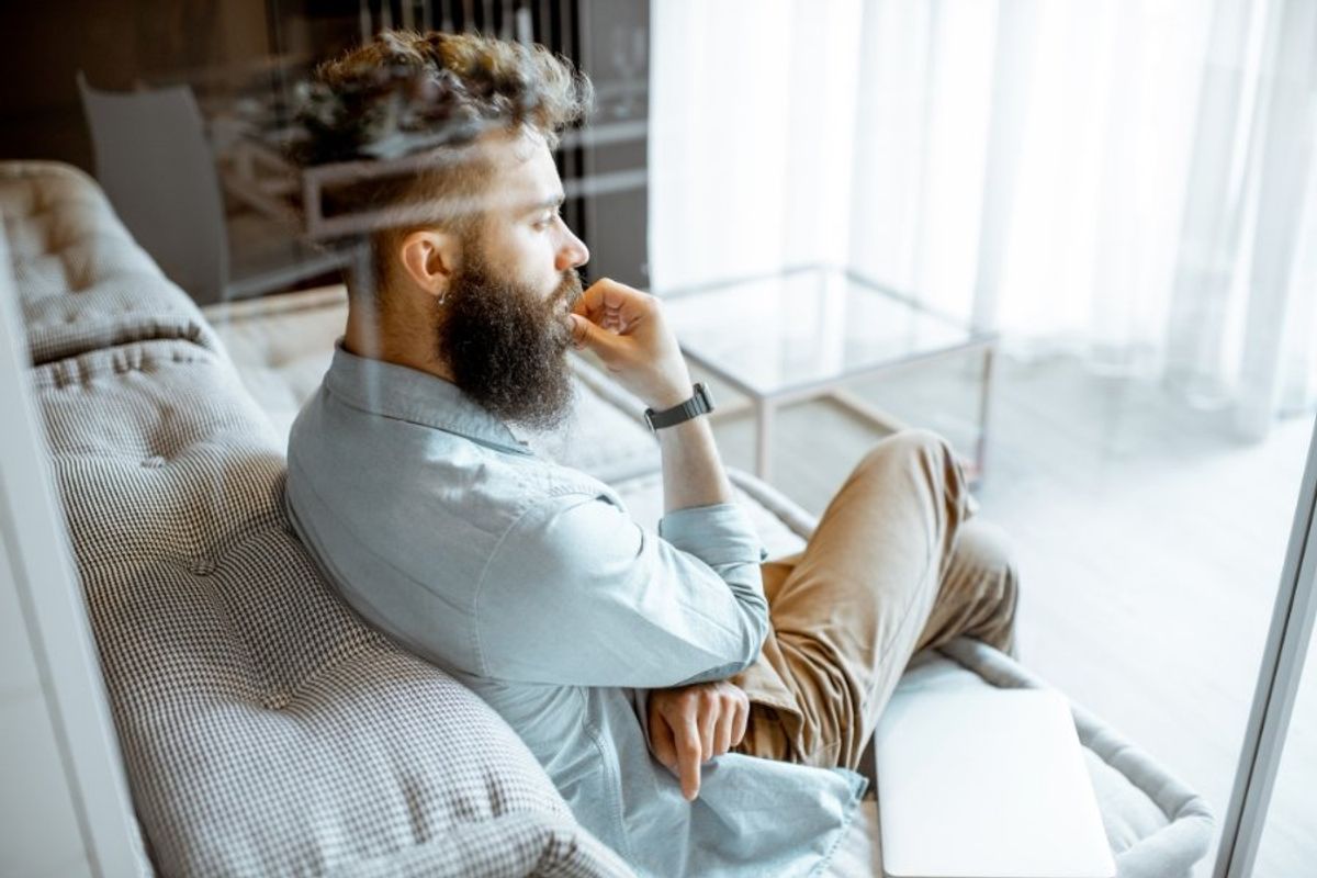 man sitting looking contemplative