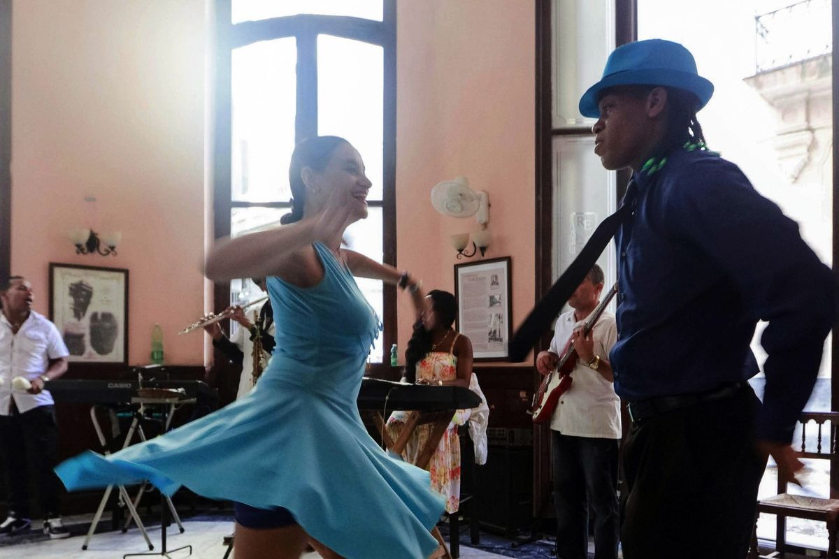 A couple salsa dancing in a club