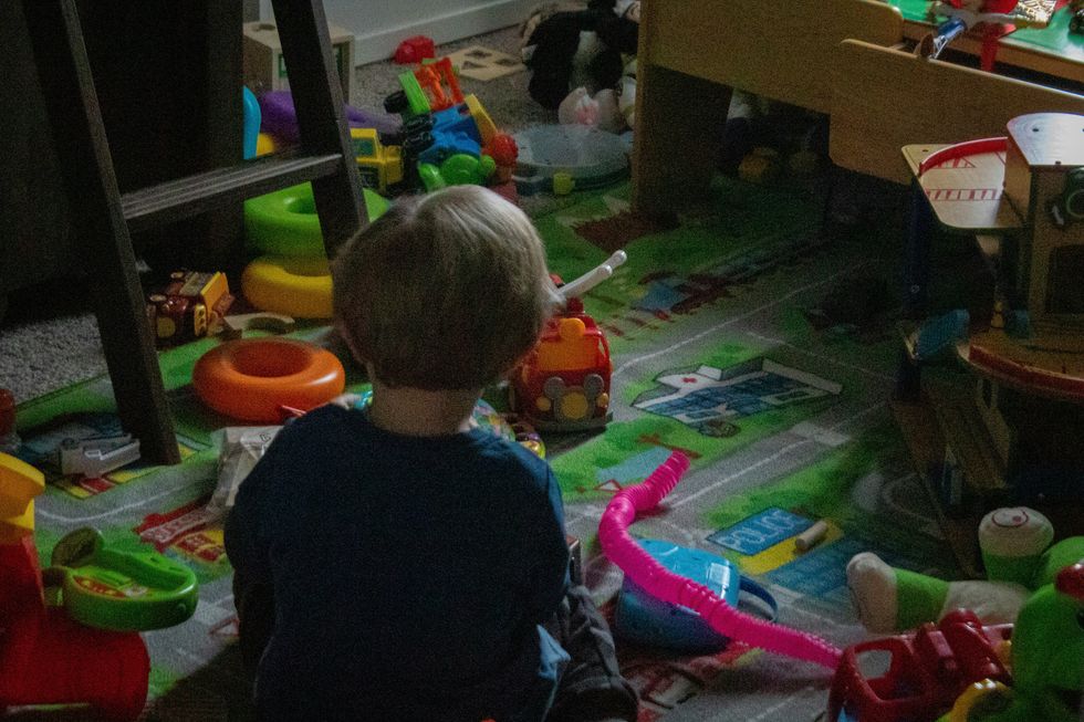 boy playing with toys on the floor