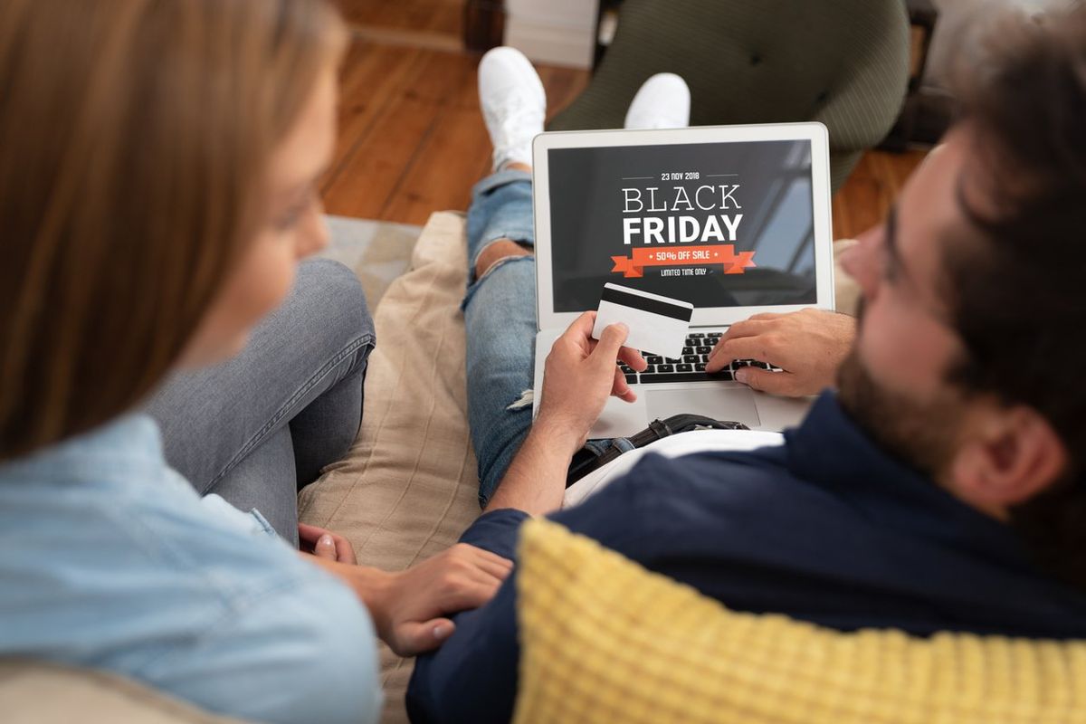 a couple shopping on a laptop for Black Friday Deals