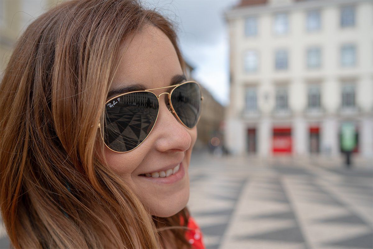 A woman wearing a pair of sunglasses. 