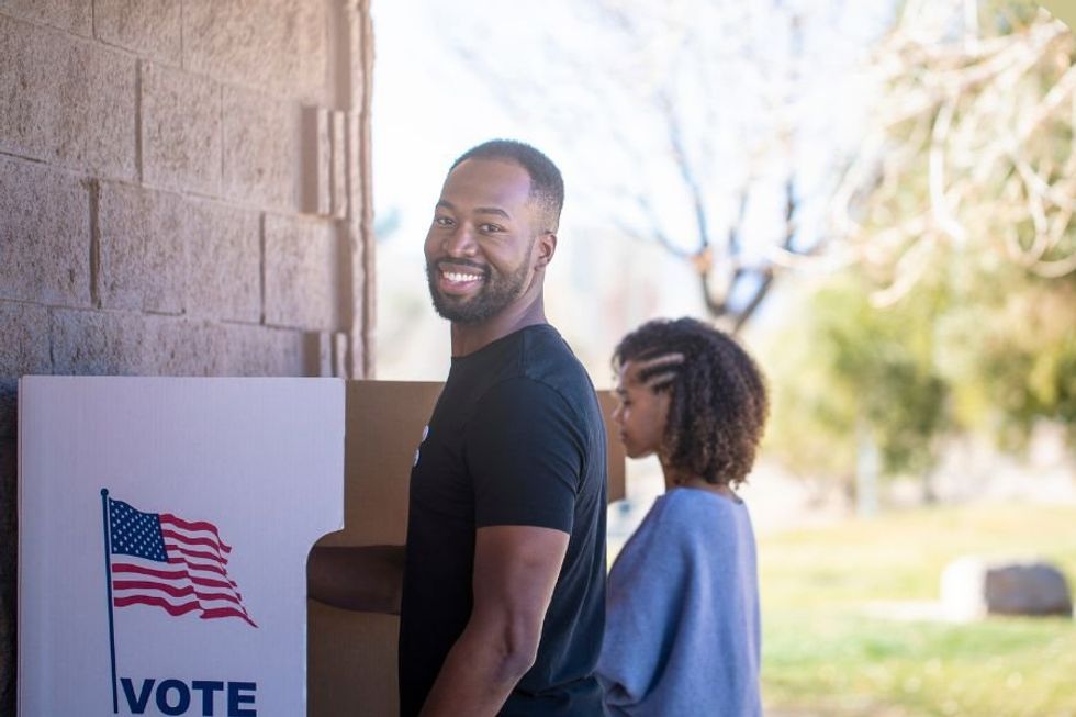 Newly naturalized citizen breaks down in tears about his experience voting for first time