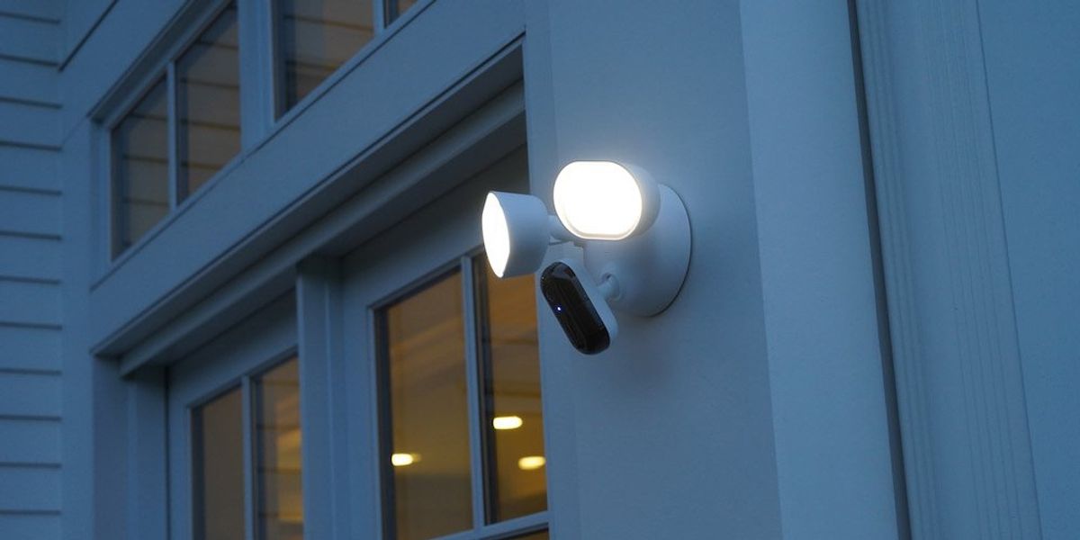 a photo of Arlo Wired Floodlight Camera installed outside on a home at night