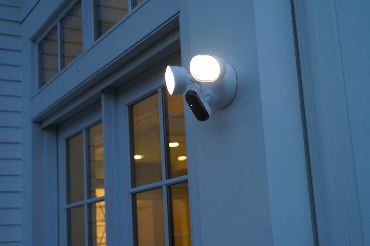 a photo of Arlo Wired Floodlight Camera installed outside on a home at night