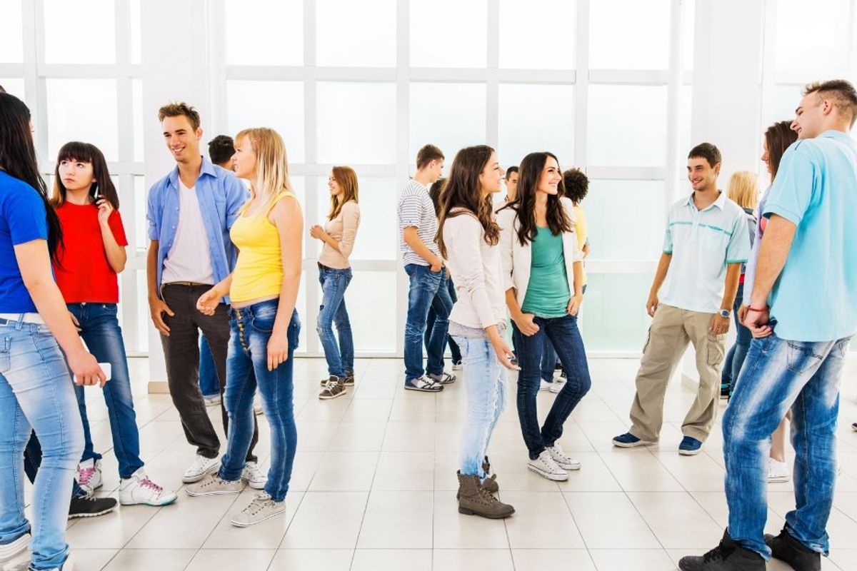 group of people socializing in a large room