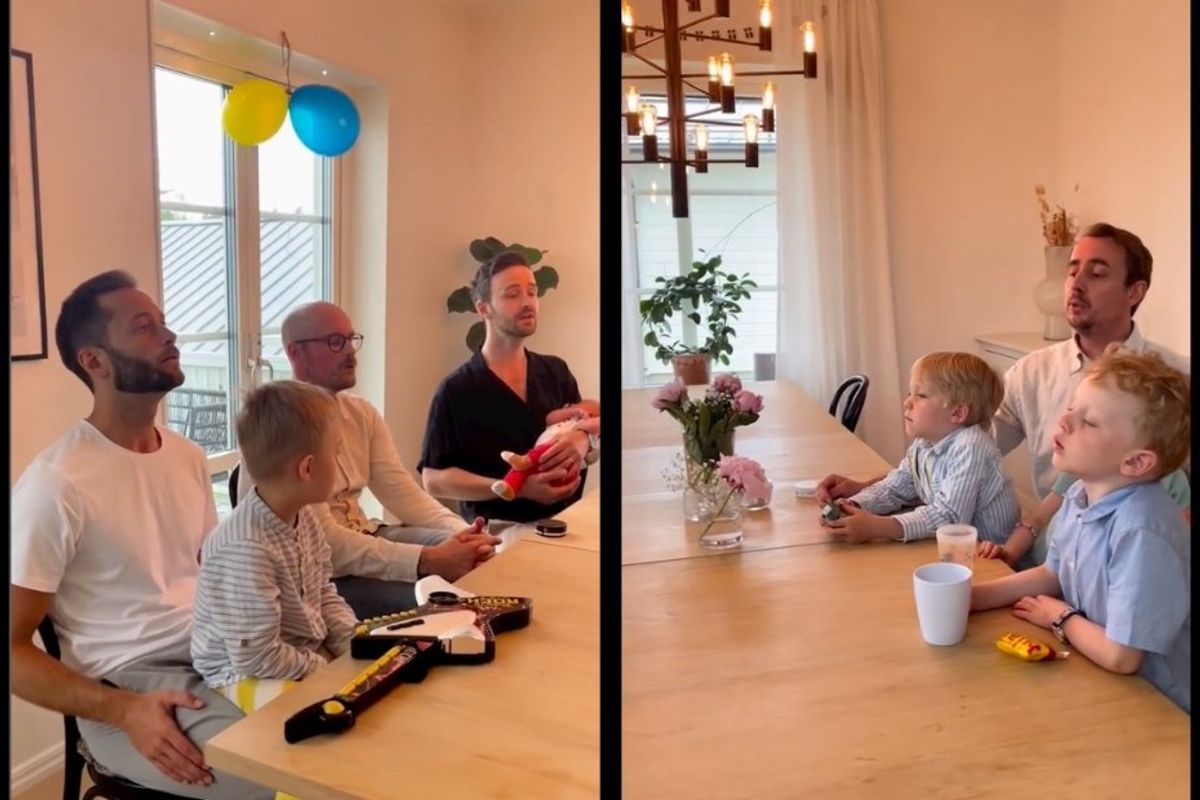 dads singing with kids around a dining table