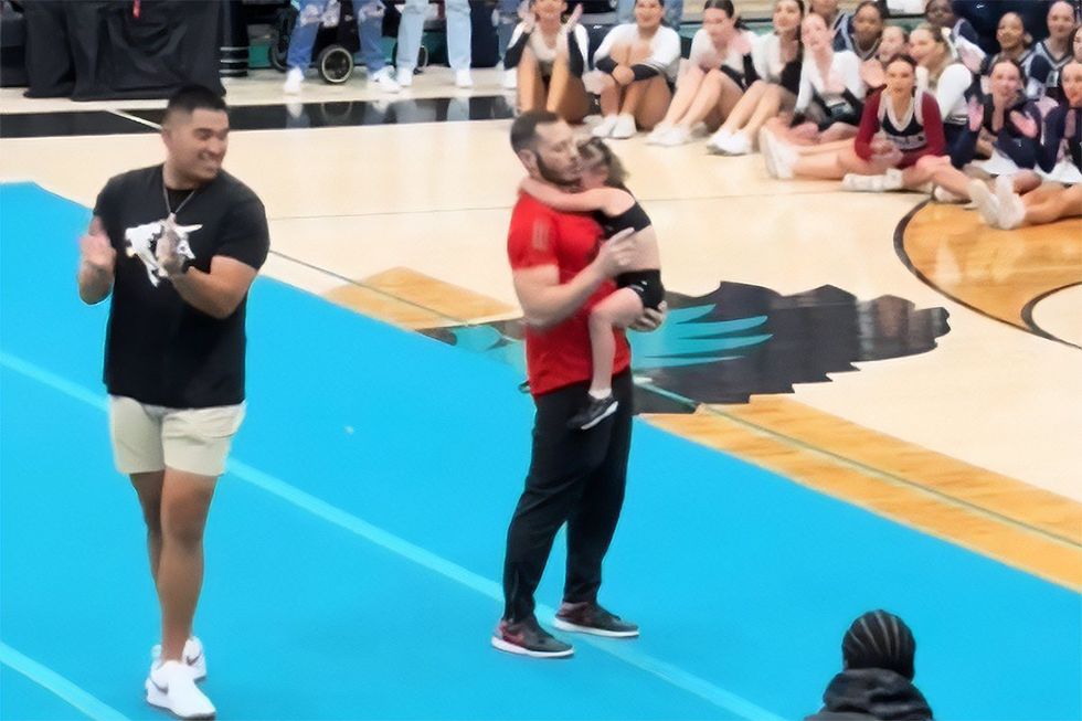 A young cheerleader tearfully froze mid-routine but her coach pushed her try it one more time