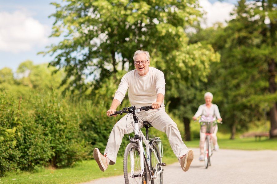 man joyfully riding a bike