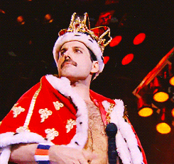 a gif of Freddie Mercury dressed as a king.
