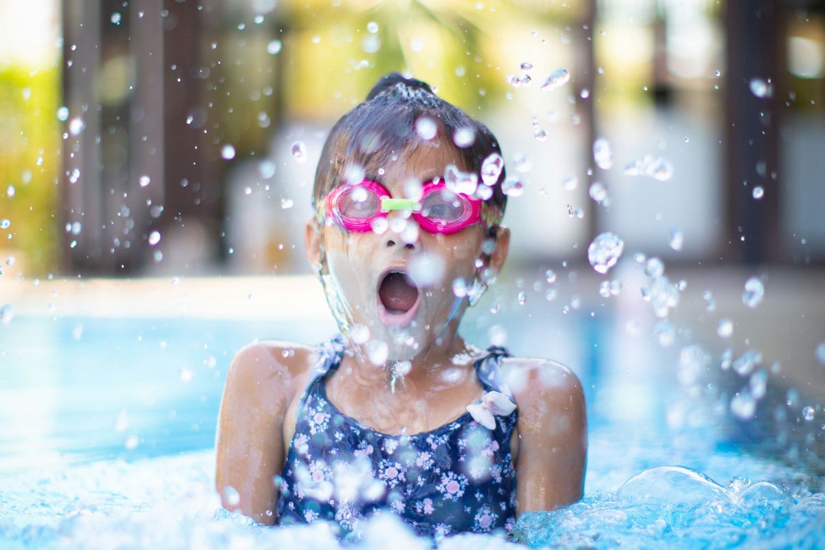 girl swims in swimming pool