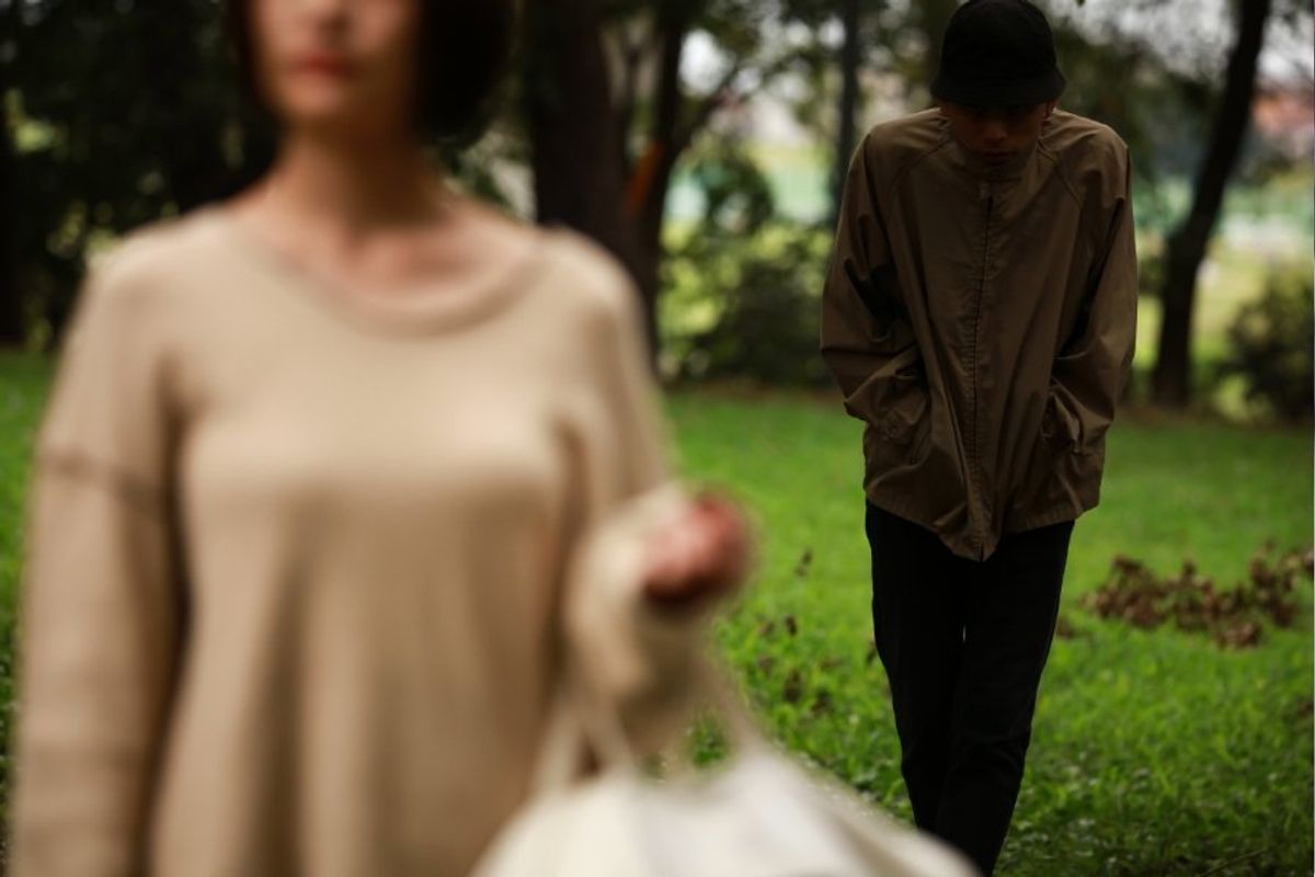 man following a woman