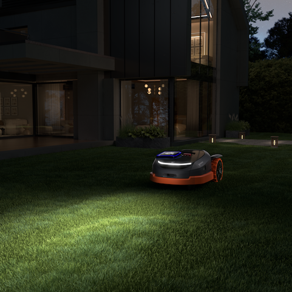 photo of Navimow X3 mowing at night time on a lawn