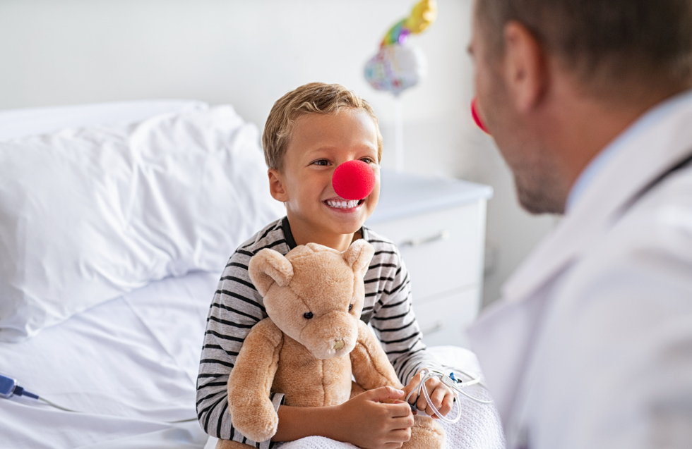 Doctor and child patient wearing clown noses