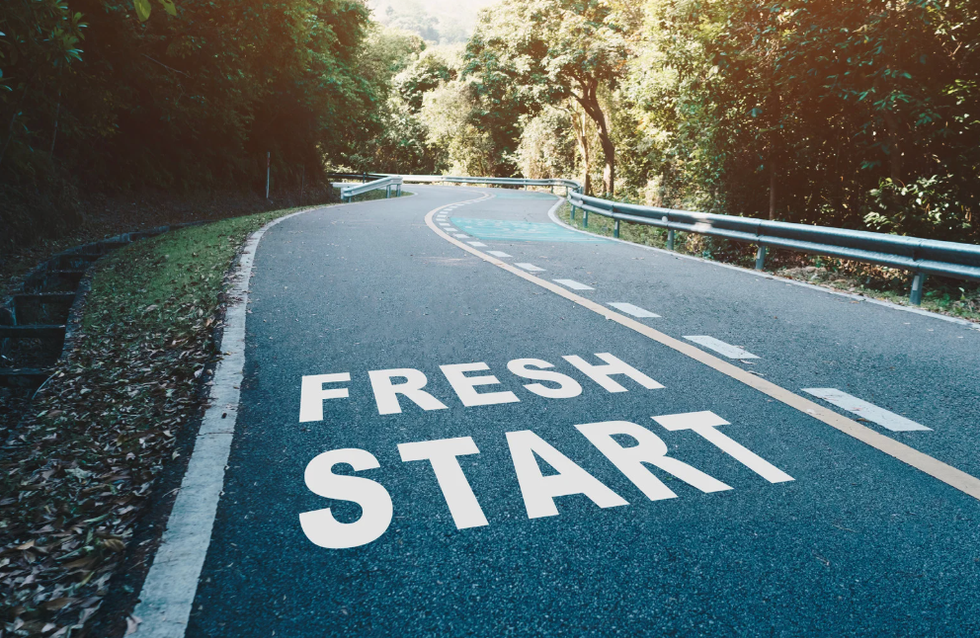 A road with the words "FRESH START" written on the pavement.