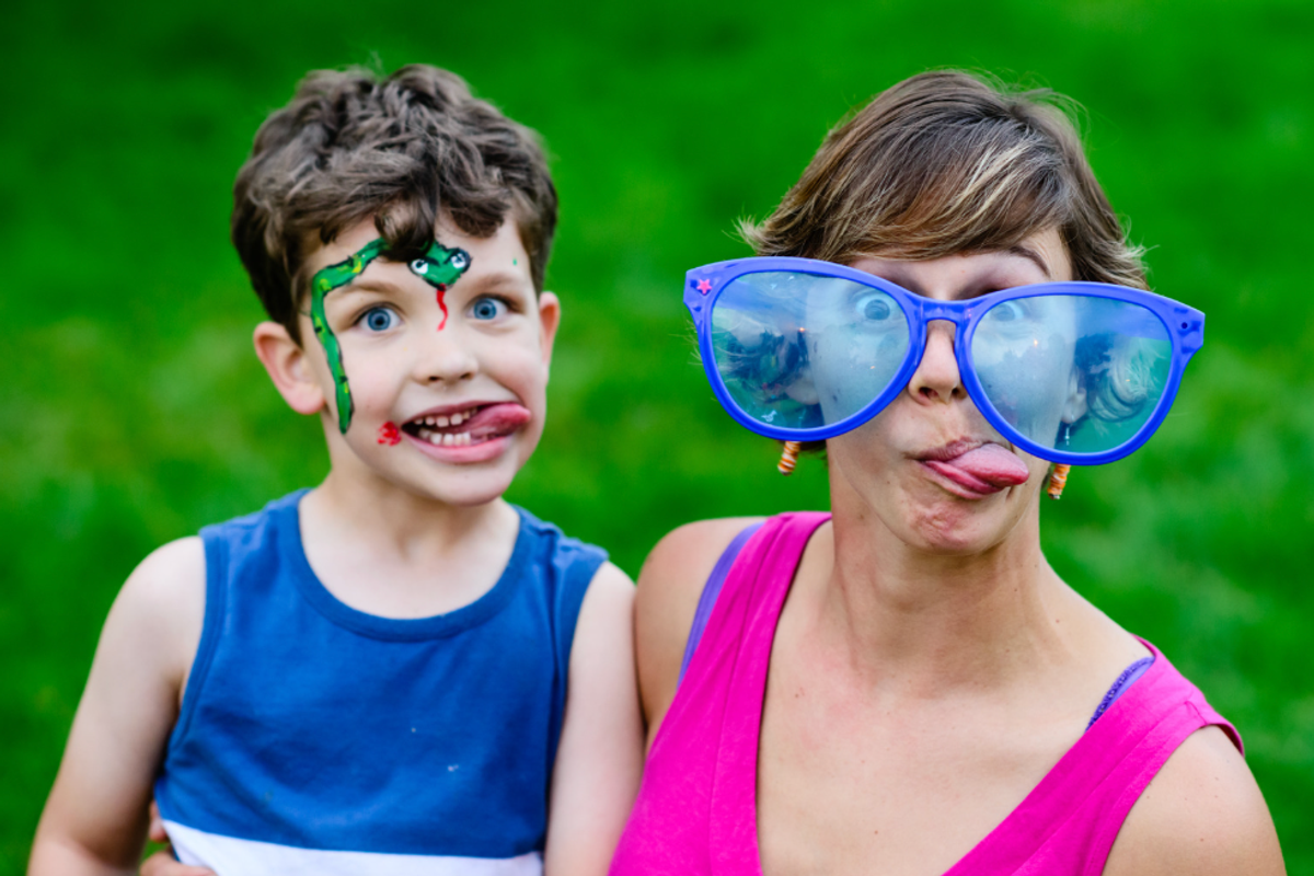 Mother and son being goofy together, sticking their tongues out